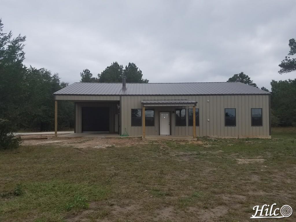 Tan (brown) barndominium with dark metal roofing